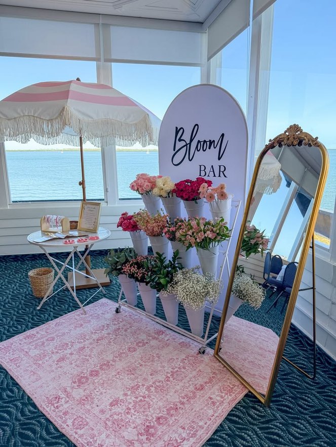 The KinLove Bloom Bar cart with flower cones, a parasol and a gilt mirror, set up by the sea in Cagayan de Oro
